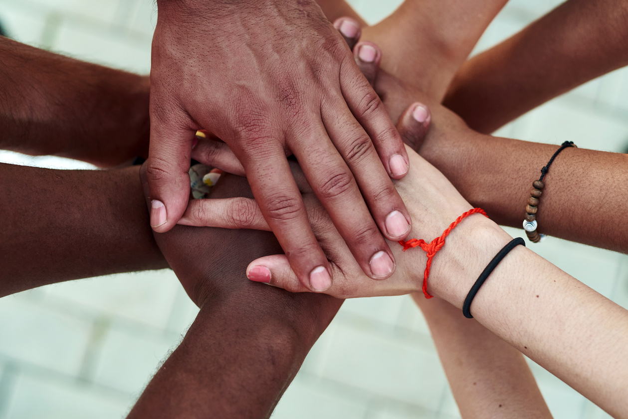 Group of People with Hands Stacked Together 